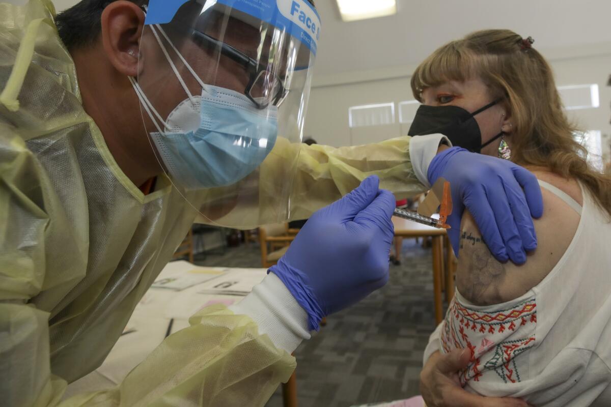 A woman receives a COVID-19 vaccine