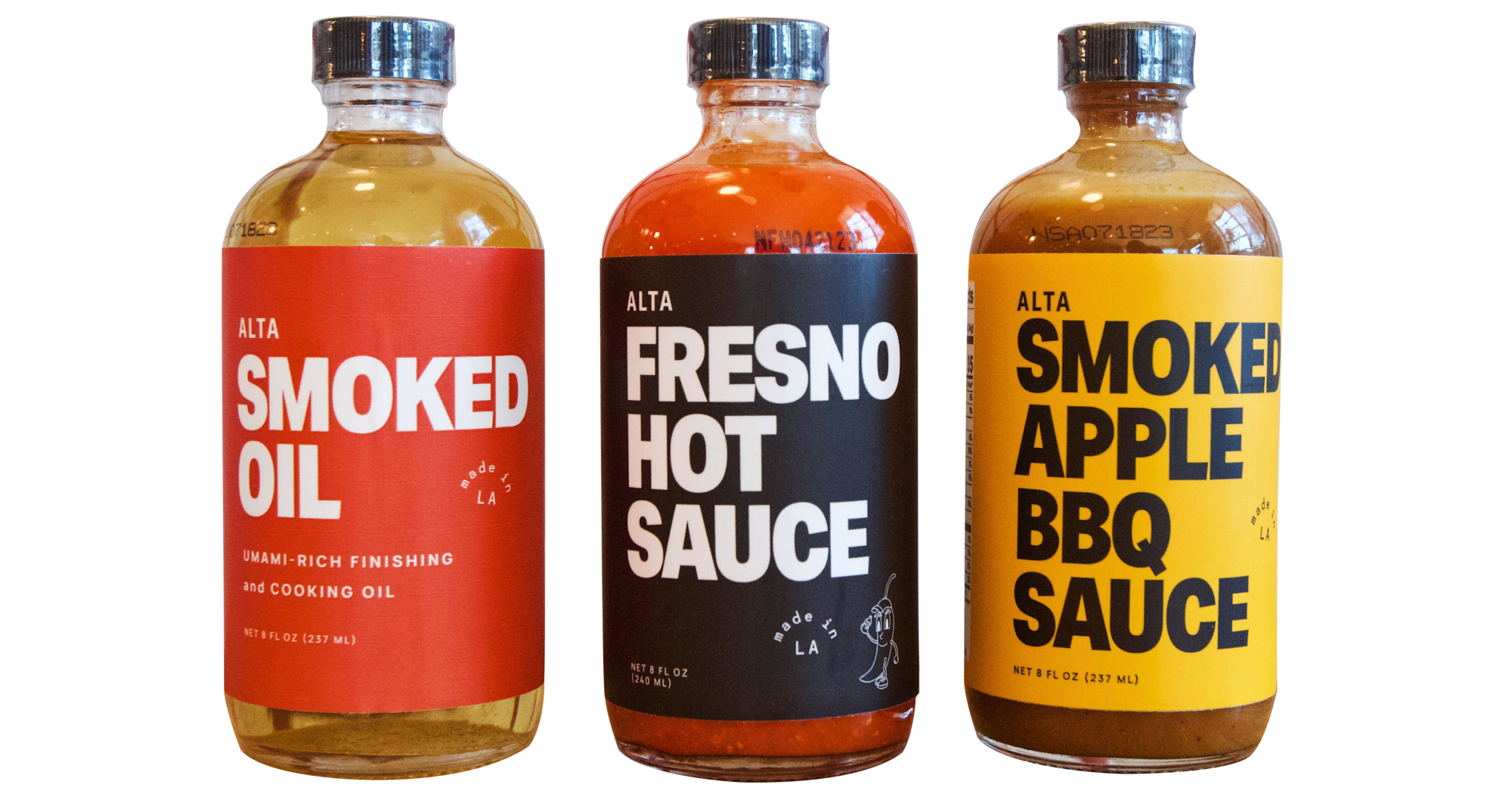 Three bottles of Alta pantry sauces: smoked oil, Fresno hot sauce and smoked apple BBQ