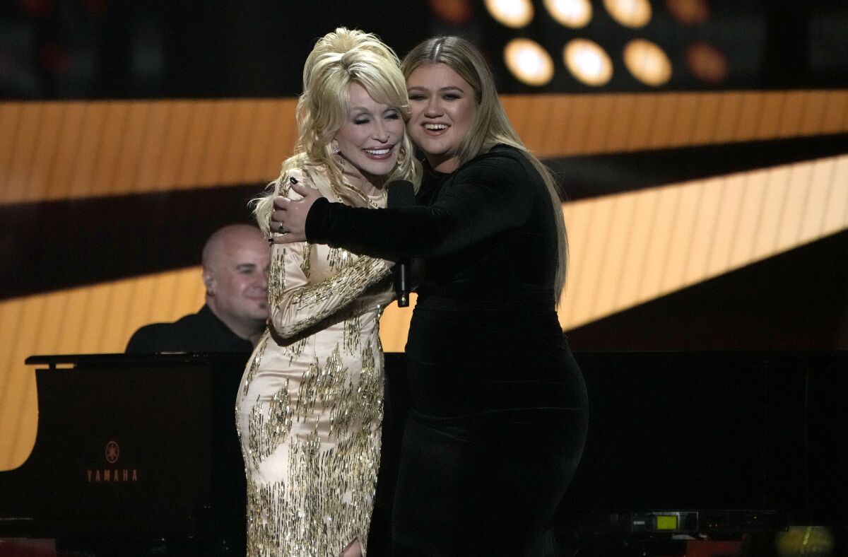 Two women embrace onstage.