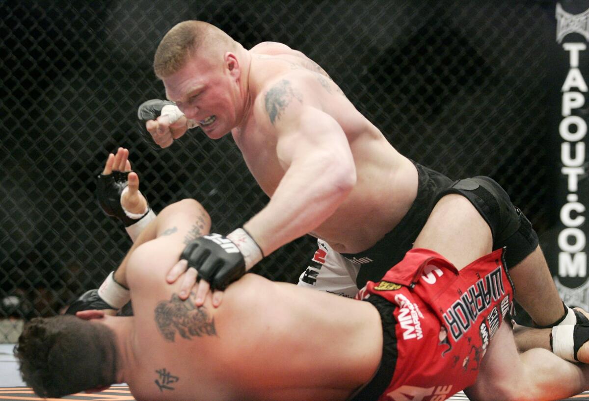 Brock Lesnar, top, fights Frank Mir during the first round of a UFC heavyweight bout in February 2008.