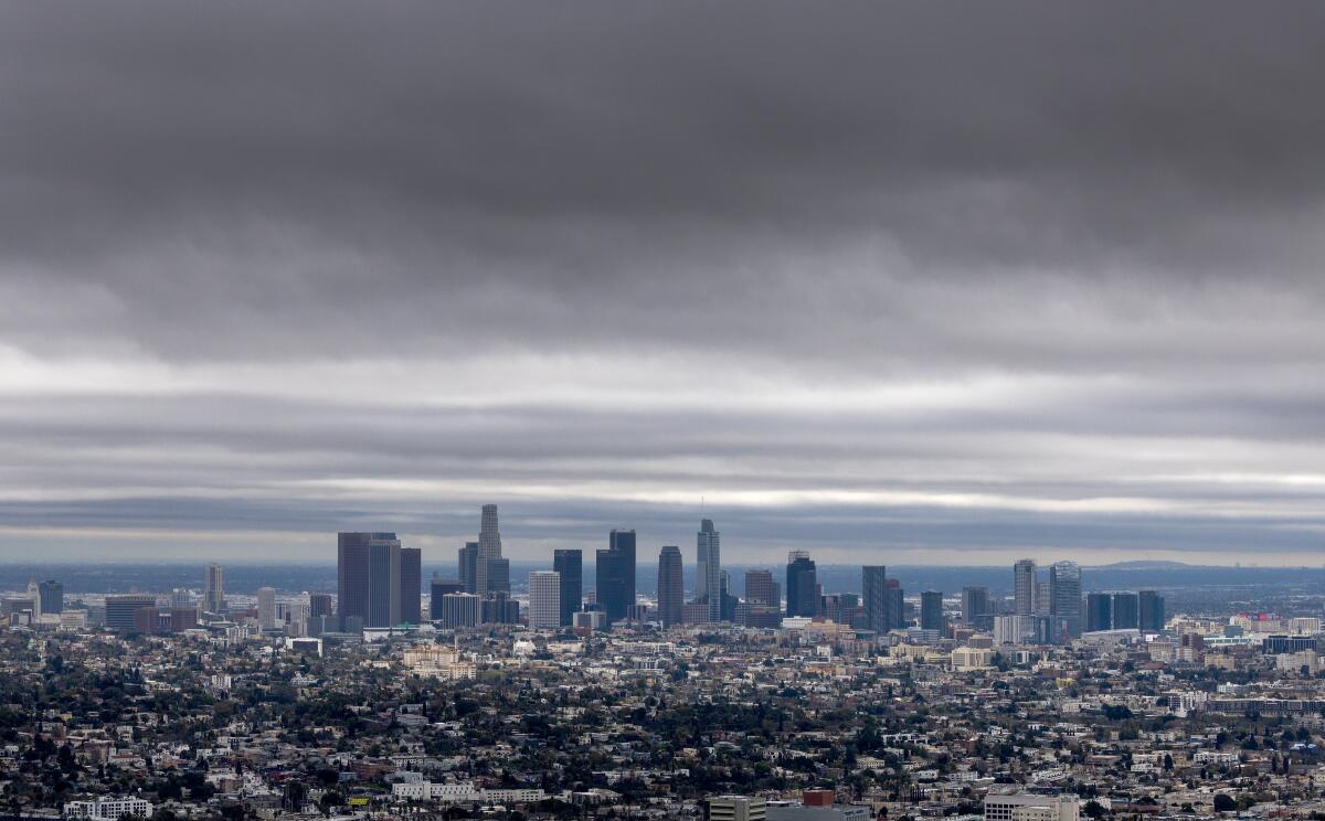 Storm clouds linger over the Los Angeles Basin in a view of the downtown skyline and surrounding area,