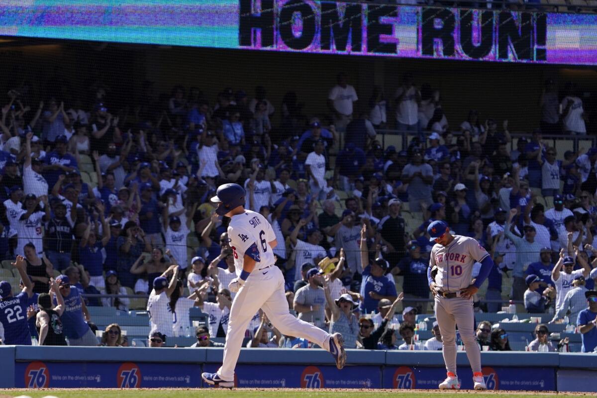 Will Smith, left, rounds third after hitting a solo home run in the ninth inning Sunday.