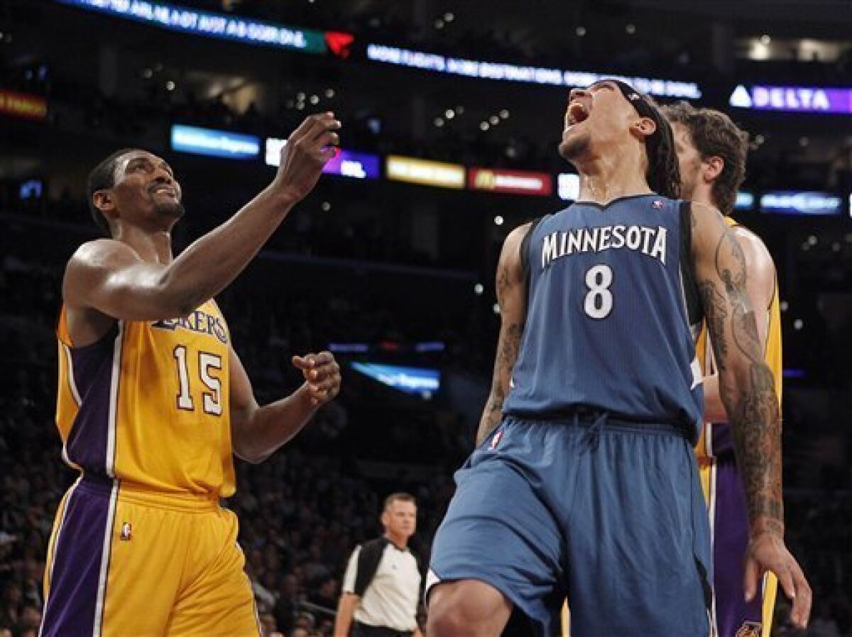 Minnesota Timberwolves forward Michael Beasley, right, reacts after a foul call on Los Angeles Lakers forward Ron Artest, left, during the first half of an NBA basketball game in Los Angeles, Tuesday, Nov. 9, 2010. (AP Photo/Jae C. Hong)