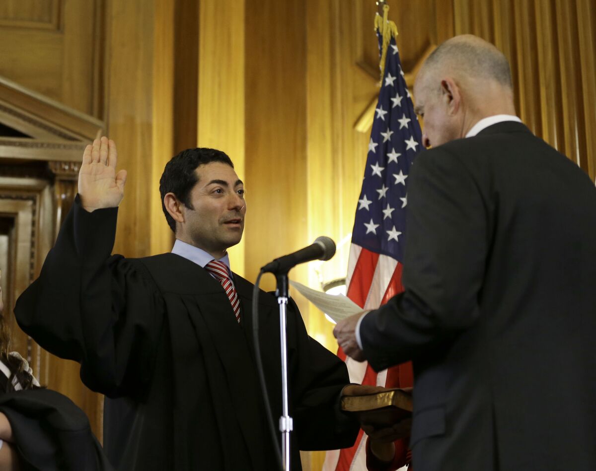 Mariano-Florentino Cuéllar, left, is sworn in as an associate justice to the California Supreme Court by Gov. Jerry Brown.