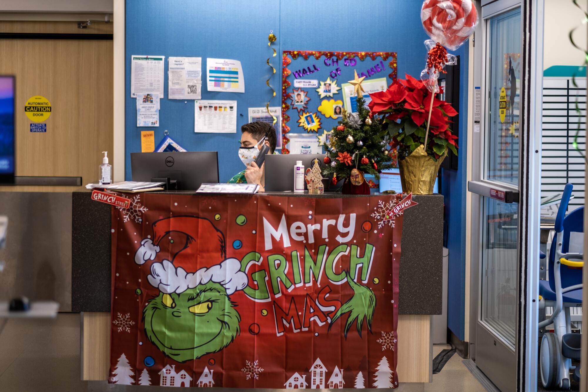 Nurse Joshua Goodman works behind a festively decorated desk at Loma Linda University Children's Hospital