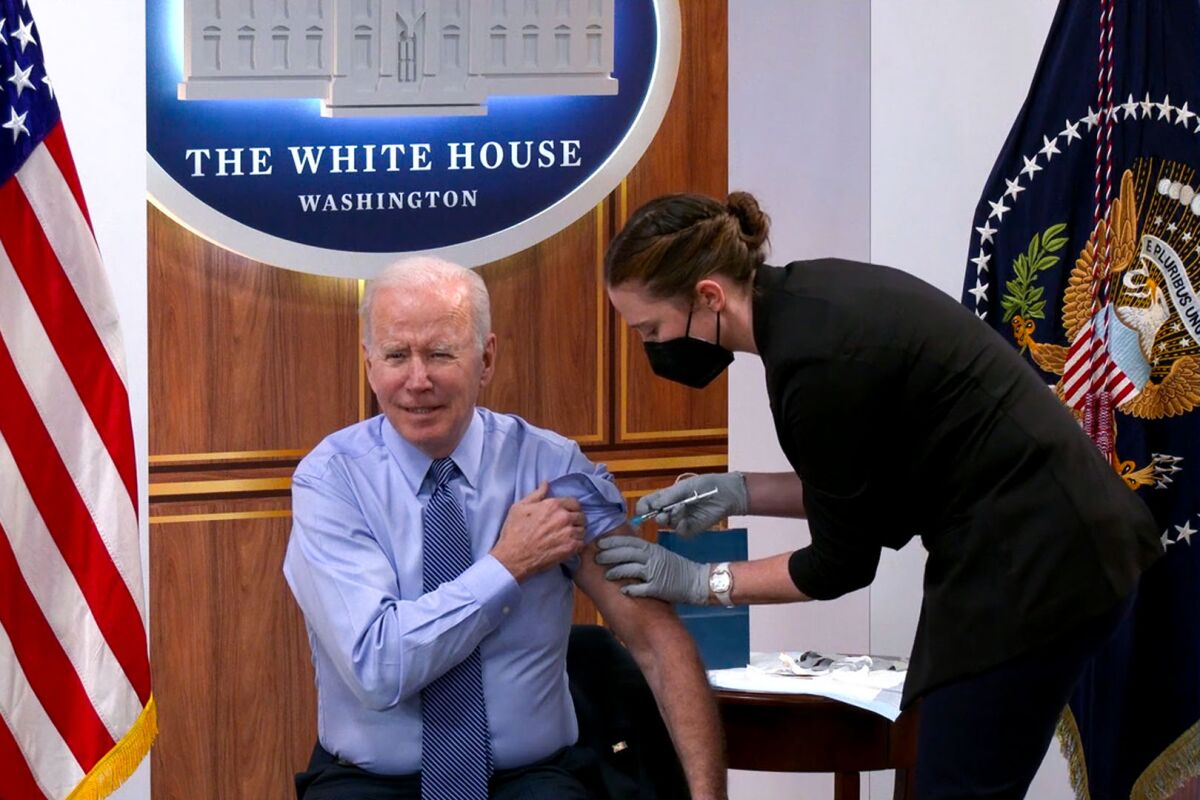 President Biden receives a COVID booster shot.