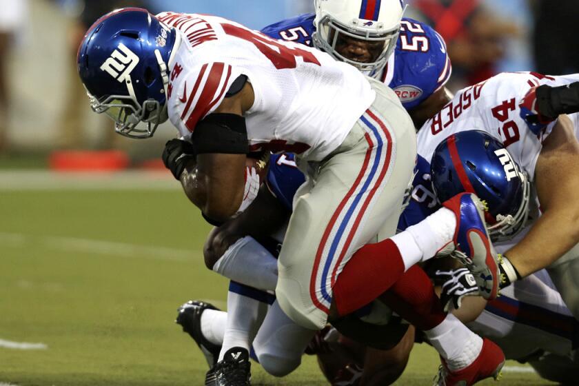 Giants running back Andre Williams power his way into the end zone on a three-yard run against the Bills on Sunday night.