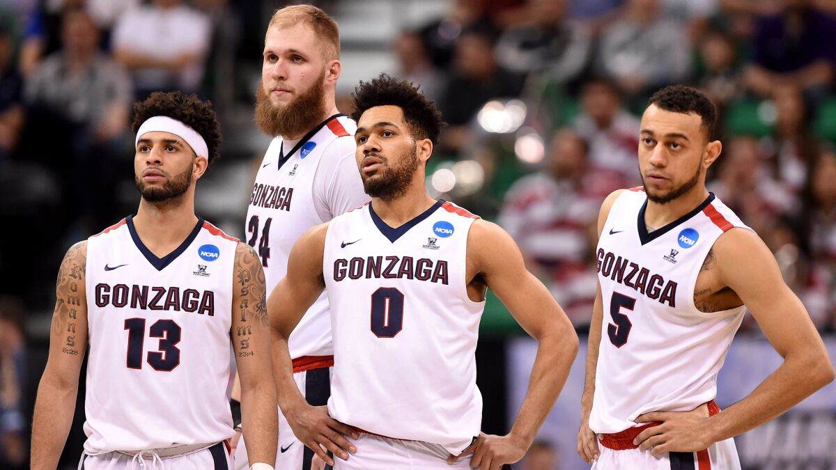 Top-seeded Gonzaga's Josh Perkins (13), Przemek Karnowski (24), Silas Melson (0) and Nigel Williams-Goss (5) came through the NCAA tournament's first weekend unscathed, unlike other highly regarded teams.