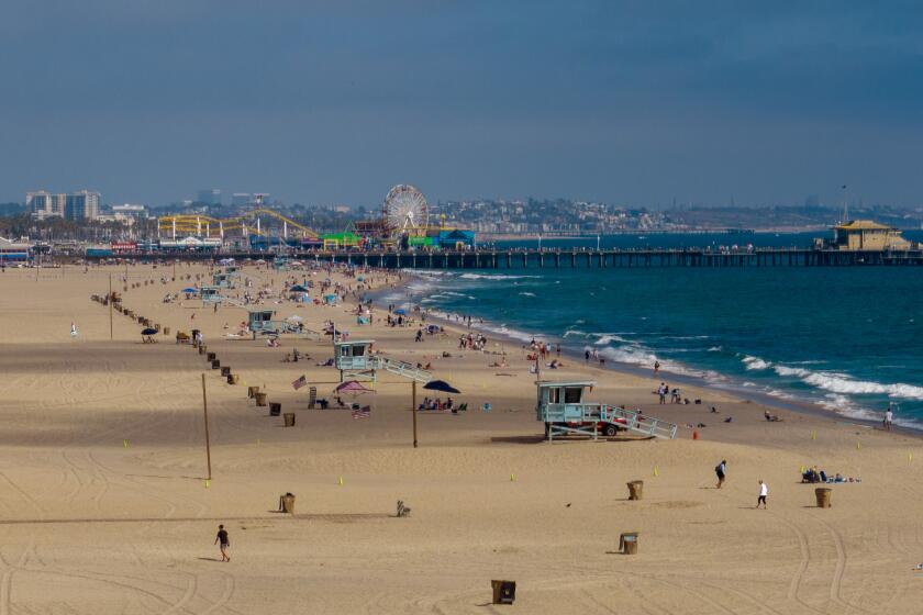 Santa Monica, CA - June 30: The sand around the Santa Monica Pier will be packed this weekend as high pressure builds sending inland temperatures into the triple digits. Photographed on Friday, June 30, 2023 in Santa Monica, CA. (Brian van der Brug / Los Angeles Times)