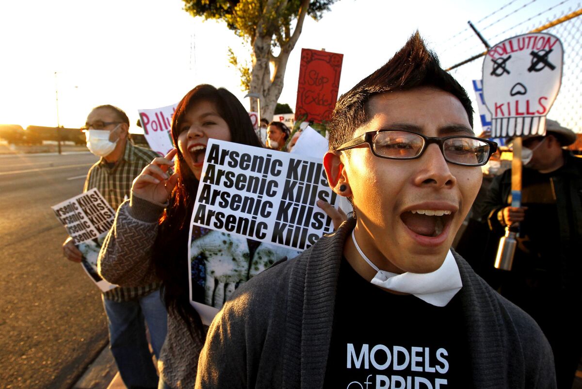 Juan Rosales, 17, right, and Rossmery Zayas, 16, both of South Gate, march outside the Exide Technologies plant.