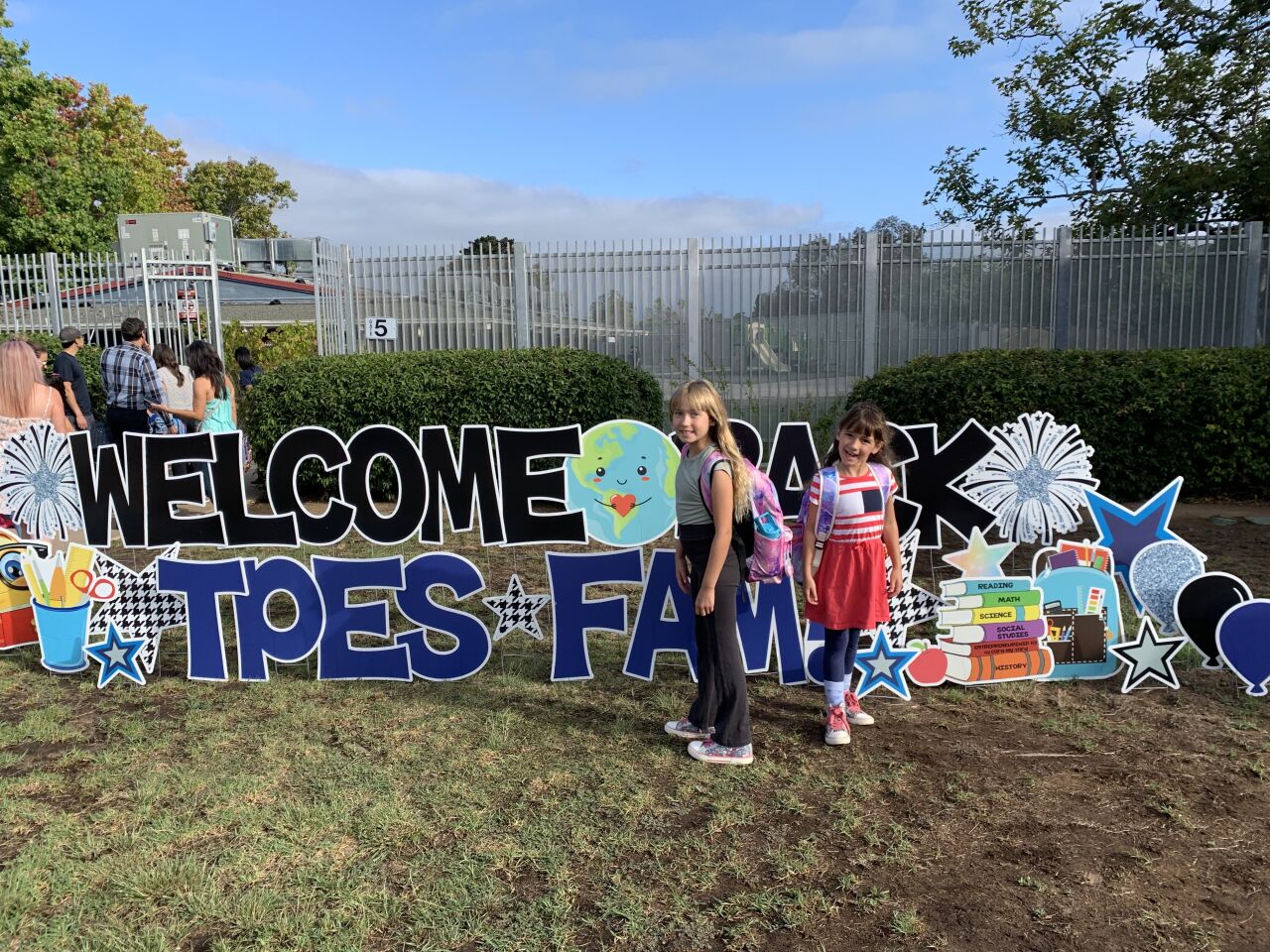 Torrey Pines Elementary School fourth-grader Ava Woodhouse and first-grader Lana Woodhouse arrive for opening day of the 2022-23 school year.