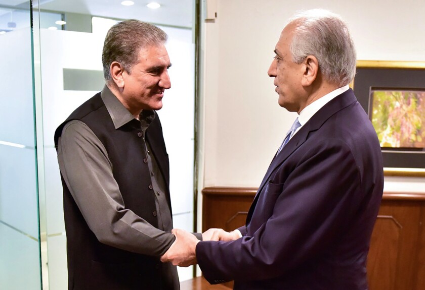 In this photo released by the Foreign Office, Pakistan's Foreign Minister Shah Mehmood Qureshi, left, meets U.S. envoy Zalmay Khalilzad at the Foreign Ministry in Islamabad, Pakistan, Friday, Jan. 31, 2020. Khalilzad has met with Pakistan's foreign minister to find a peaceful solution to neighboring Afghanistan's war. (Pakistan Foreign Office via AP)
