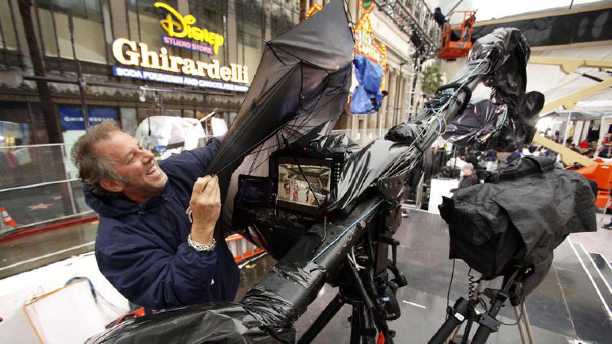 So far, no advertisers have pulled out of the Feb. 28 Oscars telecast, sources say. Above, cameraman Brian Reason struggles with equipment at a 2014 preshow event.