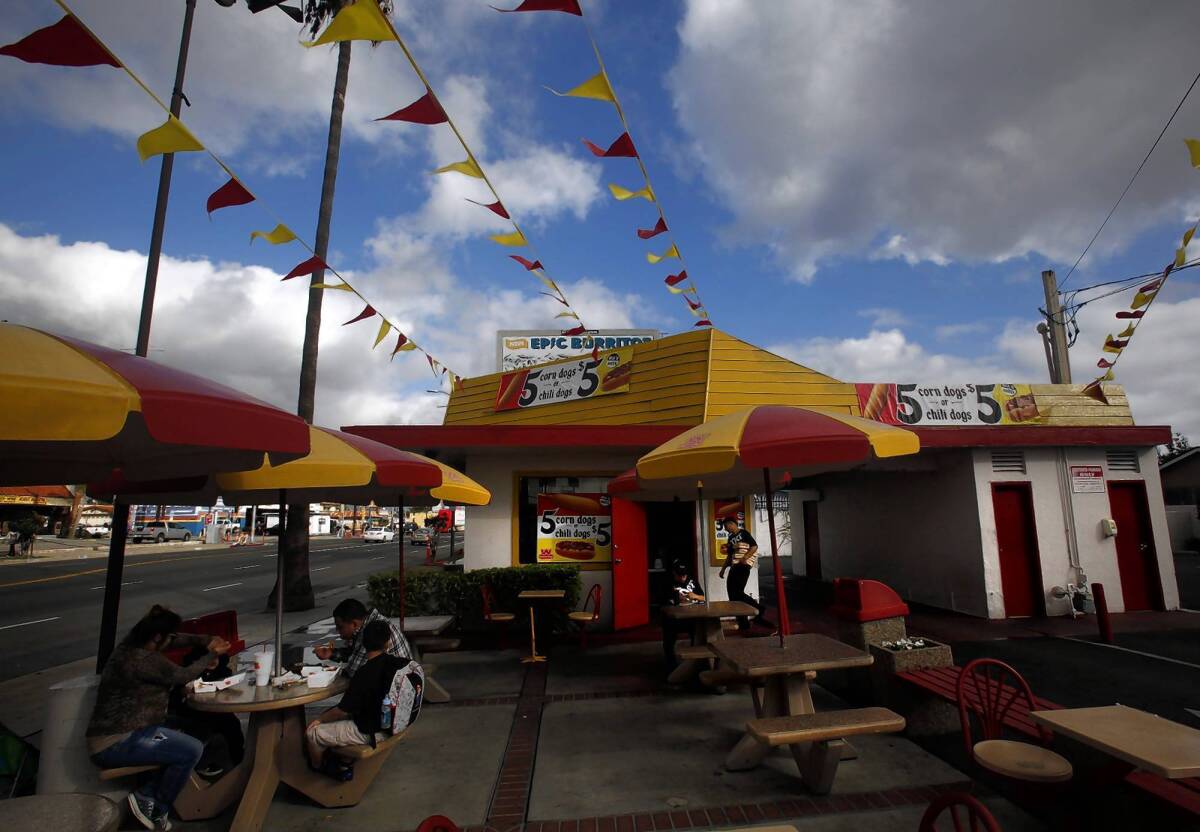 A family enjoys lunch Tuesday at the first roadside stand in the Wienerschnitzel chain in Wilmington.