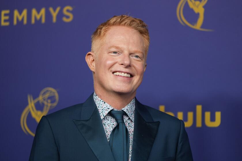 Jesse Tyler Ferguson in a patterned shirt and blue suit and tie at the 2024 Primetime Emmy Awards at the Peacock Theater