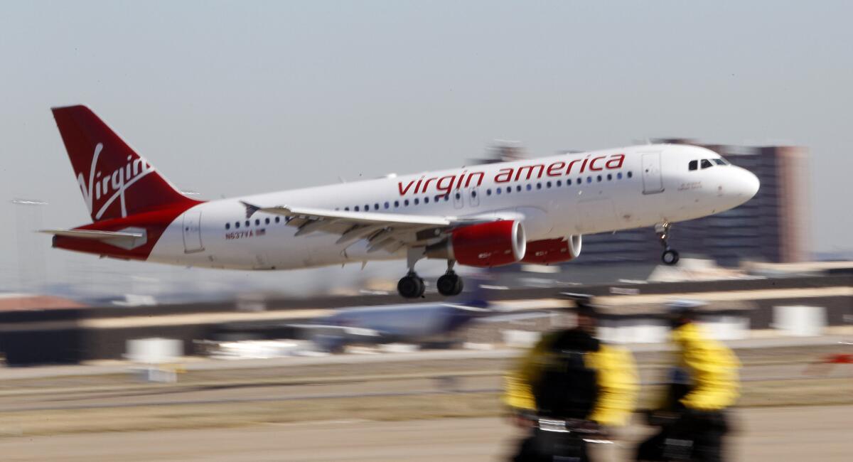 A Virgin America jet departs from Los Angeles International Airport. JetBlue Airways and Alaska Airlines have reportedly made offers to take over the California-based airline.