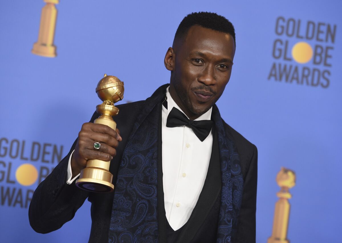 Mahershala Ali poses with the award for best performance by an actor in a supporting role in a motion picture at the 76th Golden Globes.