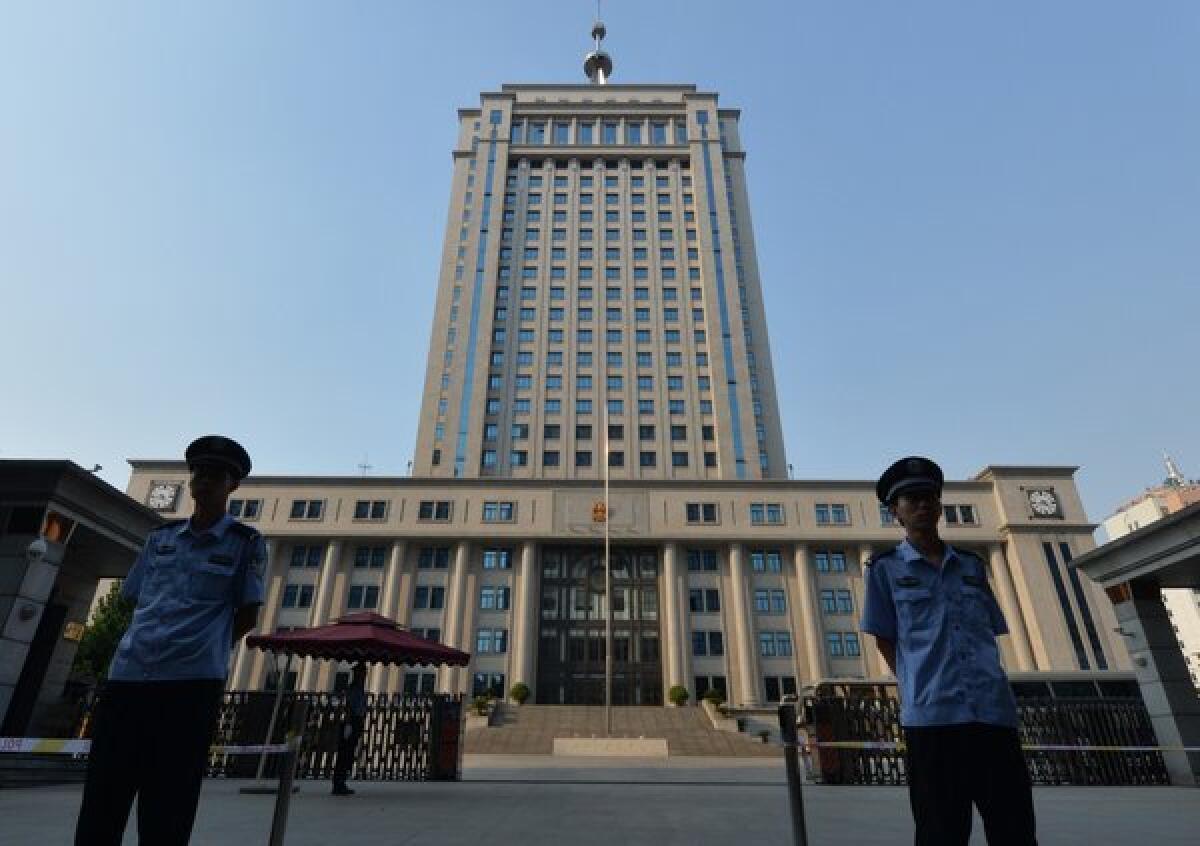 Police stand outside the Jinan People's Court where Bo Xilai, the purged Communist Party leader of Chongqing, China, goes on trial Thursday.