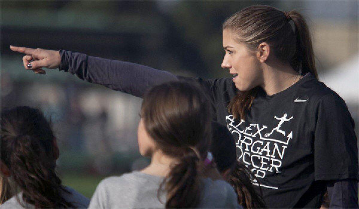 U.S. women's national team star Alex Morgan points to the next drill station at her inaugural soccer camp, which took place at the Veterans Park in Pomona on Jan. 4.