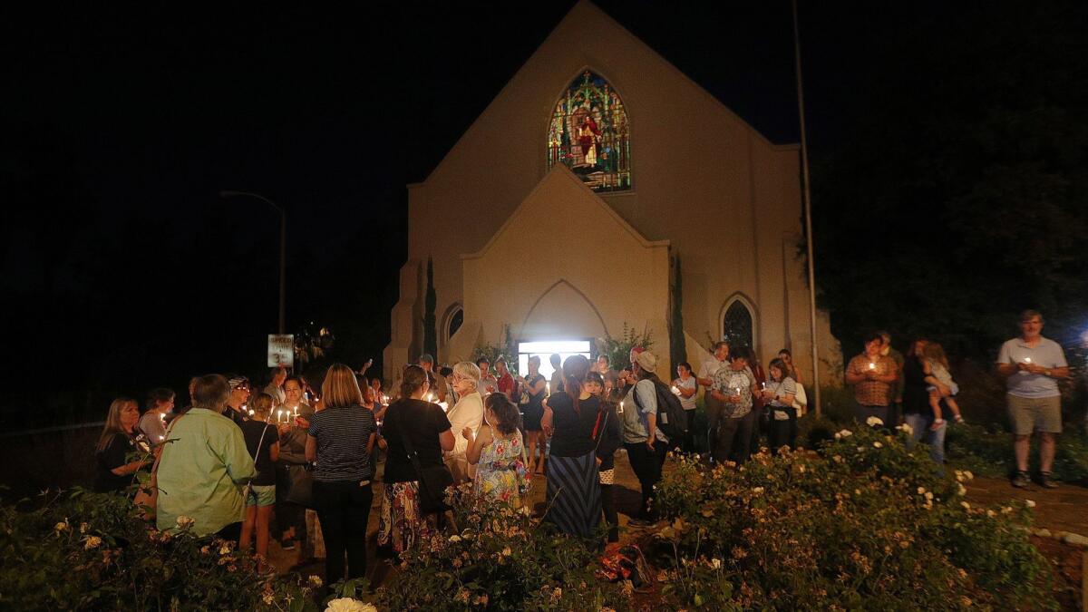 Participants gather in front of the at the La Cañada Congregational Church at a candlelight vigil for the Lights for Liberty event on Friday. The Nationwide Vigil to End Human Detention Camps had about 85 people participating locally.