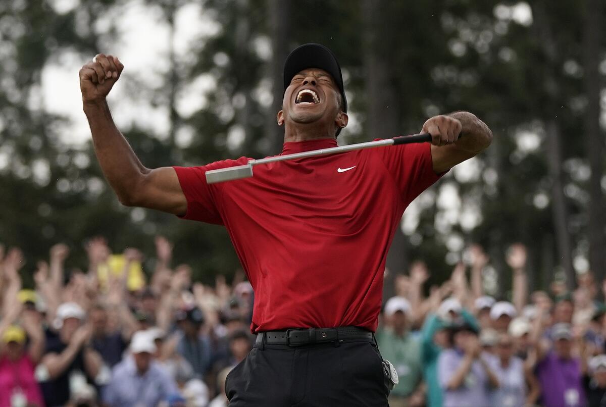 FILE - Tiger Woods reacts as he wins the Masters golf tournament Sunday, April 14, 2019, in Augusta, Ga. In a survey, this rated as his second-most significant win of his five Masters titles. (AP Photo/David J. Phillip, File)