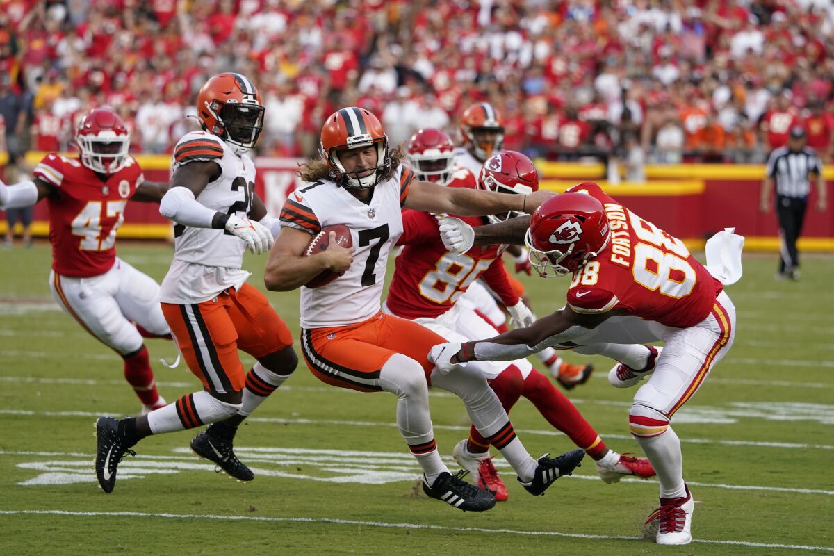 Cleveland Browns punter Jamie Gillan (7) runs with the ball after muffing a punt attempt during the second half of an NFL football game against the Kansas City Chiefs Sunday, Sept. 12, 2021, in Kansas City, Mo. (AP Photo/Ed Zurga)
