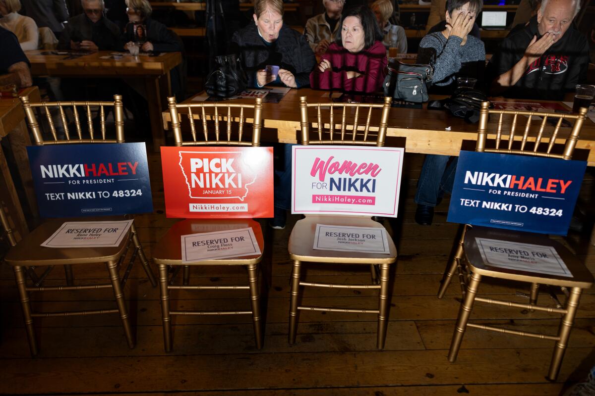 A row of chairs with Nikki Haley posters propped on them.