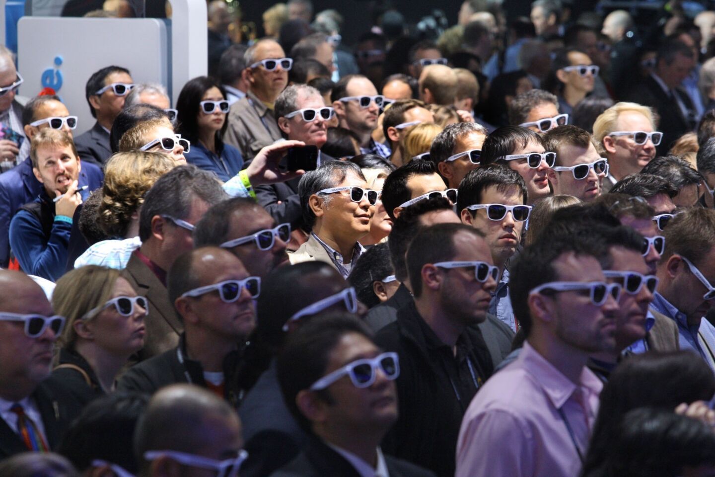 Members of the press wear polarizing sunglasses at the premiere of the Volkswagen Beetle convertible at the L.A. Auto Show at the Los Angeles Convention Center in Los Angeles on November 28, 2012. The glasses helped the audience better see projections during the cars presentation. The Beetle convertible will be available in three special editions upon launch in December 2012.