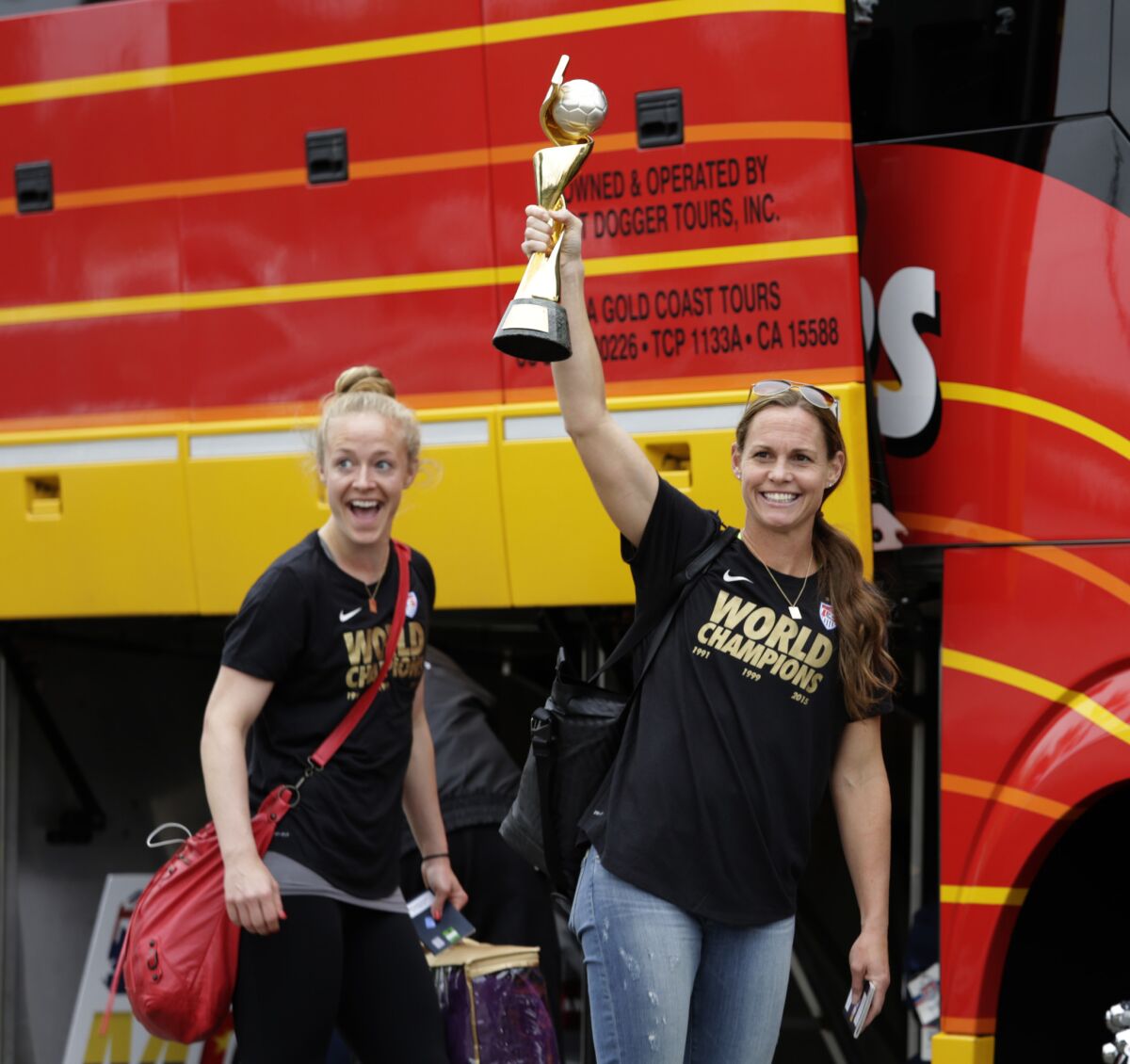 LOS ANGELES, CA JUL. 06, 2015. U.S. WOMEN'S NATIONAL TEAM captain Christie Rampone with the world cup and teammate Becky Sauerbrunn arriving at LAX from Canada on Jul 06, 2015. U.S. WOMEN'S NATIONAL TEAM arriving at LAX after wining the FIFA Women's World Cup in Canada.(Lawrence K. Ho / Los Angeles Times)