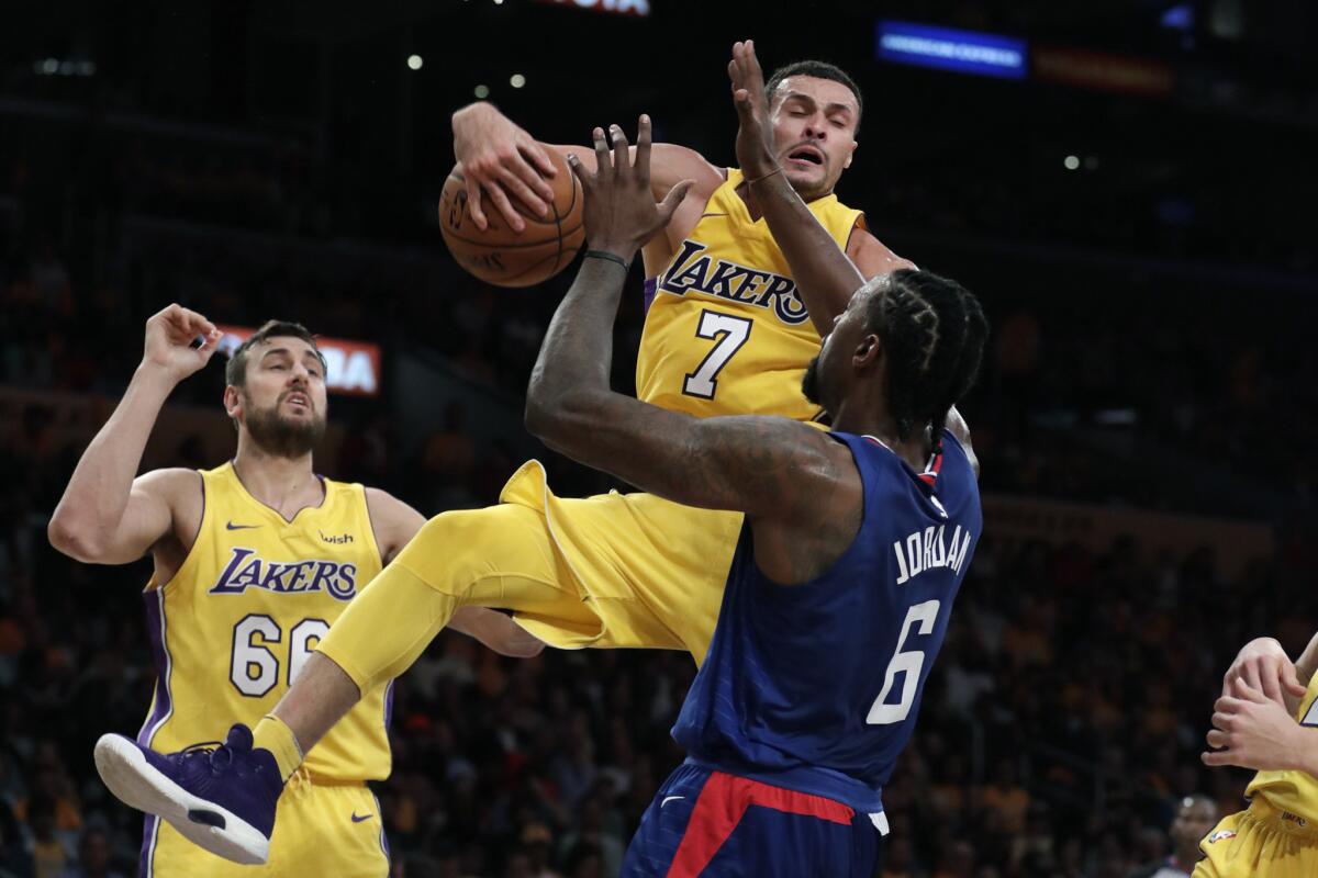 Lakers forward Larry Nance Jr. pulls down the ball after blocking a shot by Clippers center DeAndre Jordan during second half.