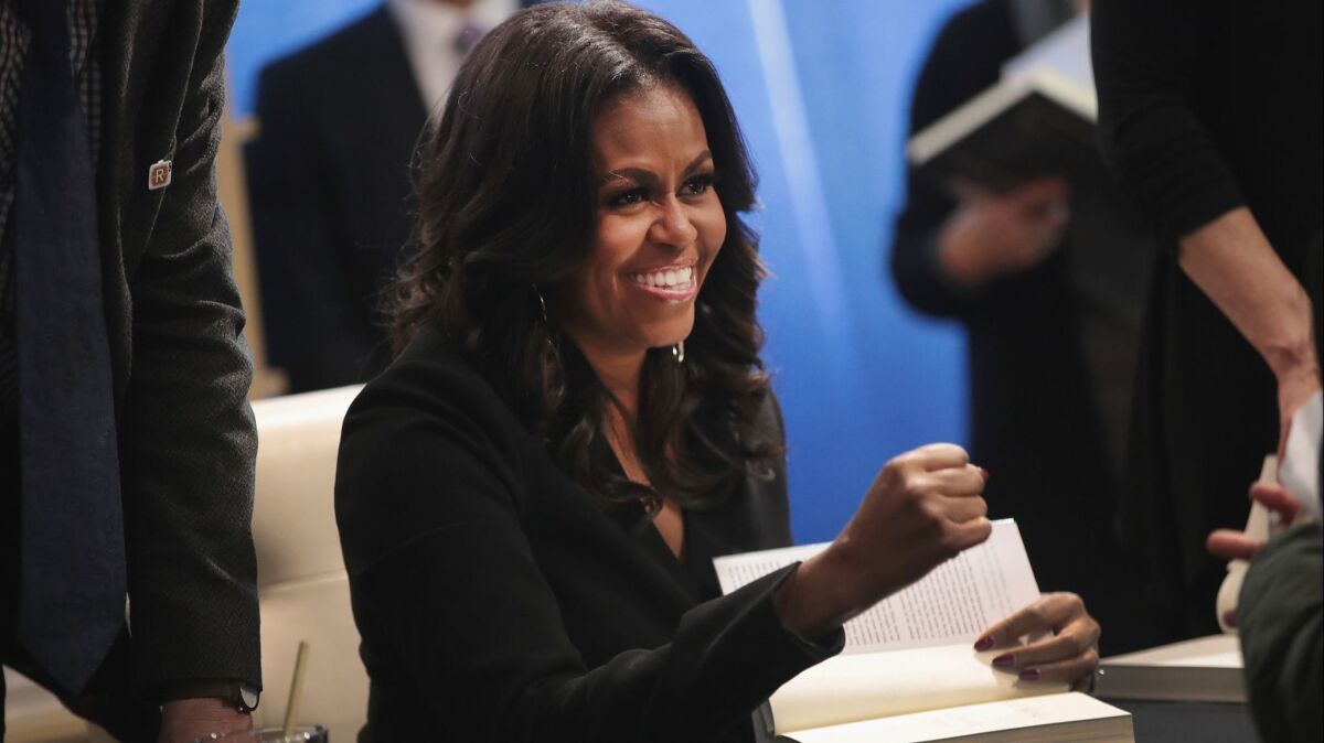 Michelle Obama signs "Becoming" on Tuesday.