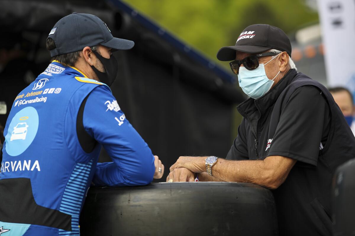 In this image provided by IndyCar, seven-time NASCAR champion Jimmie Johnson,left, speaks to four-time Indianapolis 500 winner Rick Mears before the first IndyCar practice session of the season, Saturday, April 17, 2021 at Barber Motorsports Park in Birmingham, Ala. Johnson will be an IndyCar rookie this season and make his series debut in Sunday’s opener. Mears was his childhood hero. (Joe Skibinski/IndyCar via AP)