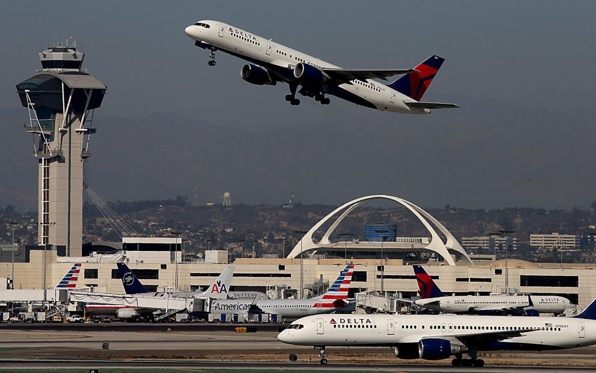 A jetliner takes off from Los Angeles International Airport, where record numbers of laser strikes on aircraft have been reported over the years.