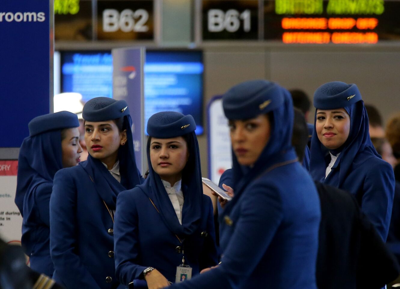 Saudia Airlines flight attendants wait to pass through a securioty checkpoint at the Tom Bradley International Terminal at LAX on Saturday.