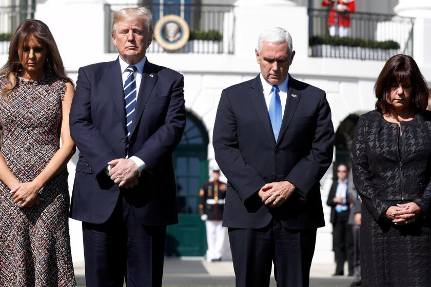 President Donald Trump and first lady Melania Trump stand with vice president Mike Pence and his wife Karen during a moment of silence to remember the victims of the mass shooting in Las Vegas, on the South Lawn of the White House in Washington, Monday, Oct. 2, 2017. (AP Photo/Pablo Martinez Monsivais)