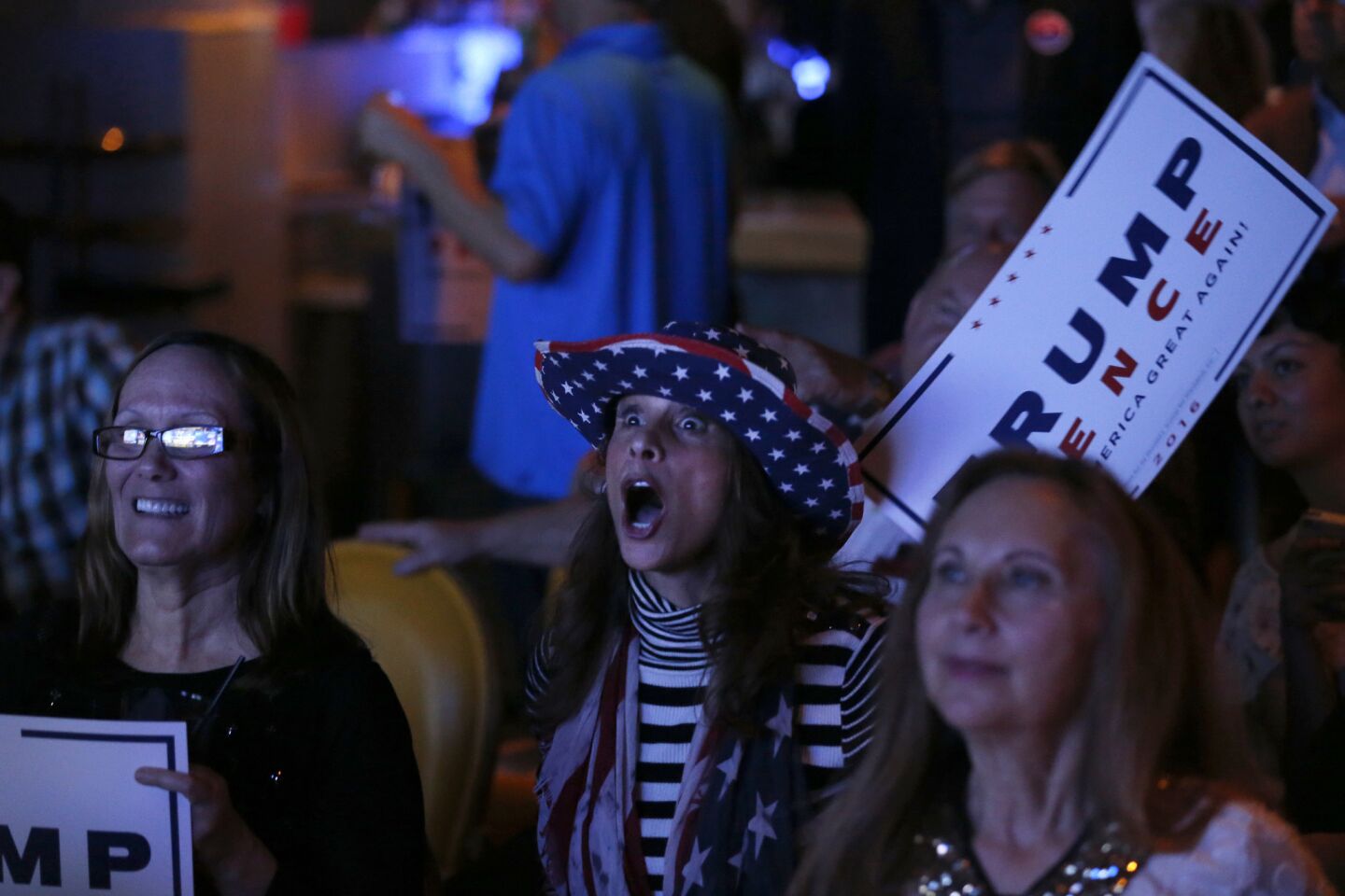Republicans Sarah McDowell, center, of Westminster, reacts while watching election night results at the OCGOP election party at China Palace in Newport Beach.