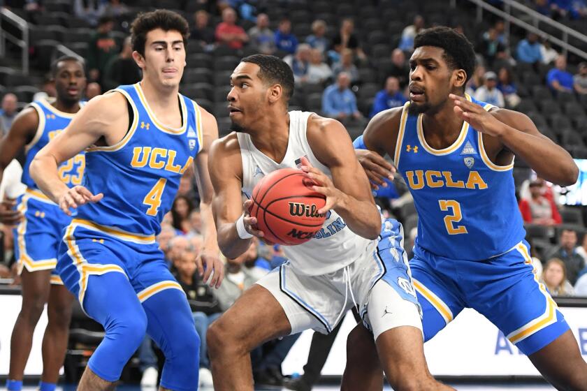 LAS VEGAS, NEVADA - DECEMBER 21: Garrison Brooks #15 of the North Carolina Tar Heels drives to the basket against Jaime Jaquez Jr. #4 and Cody Riley #2 of the UCLA Bruins during the CBS Sports Classic at T-Mobile Arena on December 21, 2019 in Las Vegas, Nevada. (Photo by Ethan Miller/Getty Images) ** OUTS - ELSENT, FPG, CM - OUTS * NM, PH, VA if sourced by CT, LA or MoD **