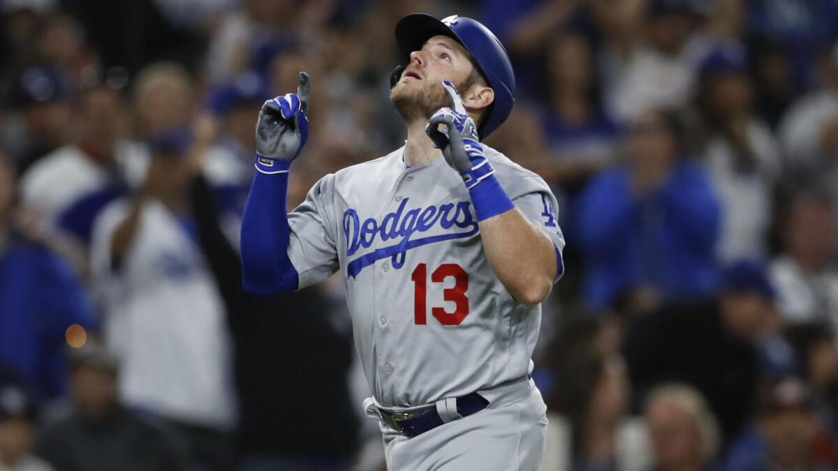 The Dodgers' Max Muncy celebrates as he approaches home plate after hitting a three-run home run during the sixth inning Saturday.