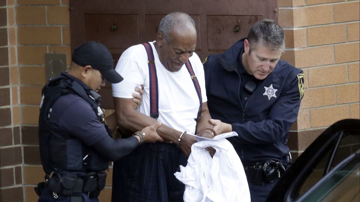 Bill Cosby is escorted out of the Montgomery County Correctional Facility in handcuffs on Sept. 25 after his sentencing for sexual assault.