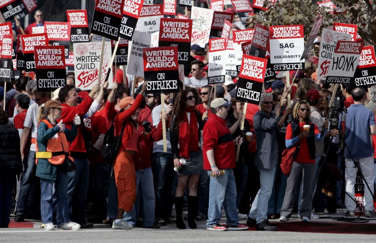 A group of striking workers hold signs during a walkout in 2007.