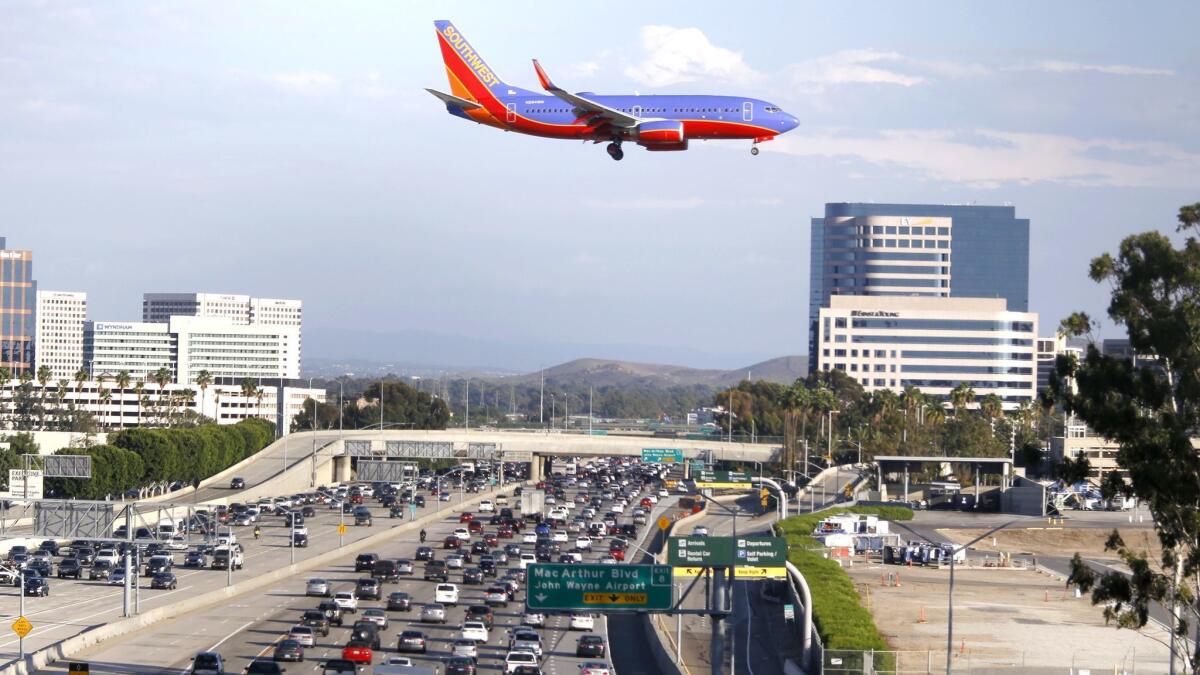 A plane comes in for a landing in 2015 at John Wayne Airport, where a truck exploded in an employee parking lot Tuesday morning.