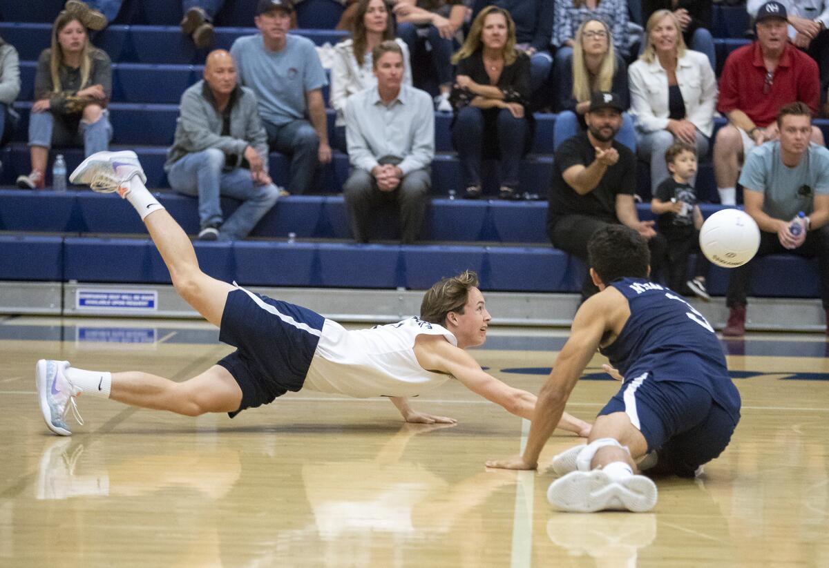 Newport Harbor High's Ryan Schroeder, left, and Joe Karlous dive for a dig during a CIF Southern Section Division 1 semifinal playoff match at Los Angeles Loyola on Wednesday.