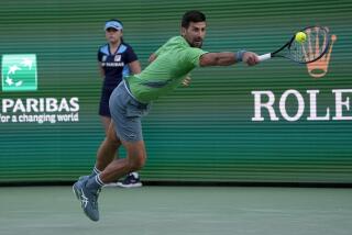 Novak Djokovic, of Serbia, returns to Aleksandar Vukic, of Australia, at the BNP Paribas Open.