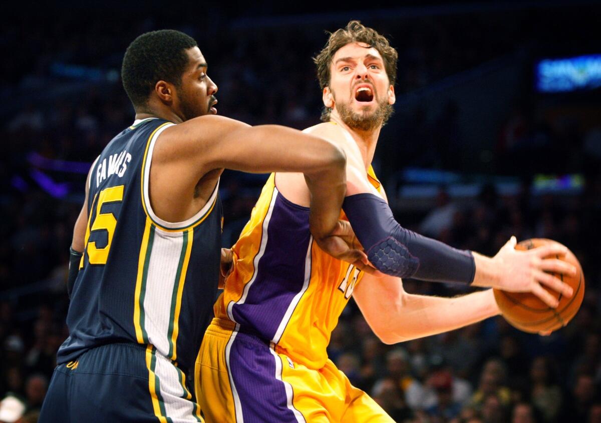 Pau Gasol tries to get past Derrick Favors during the first half of a game on Jan. 3, 2013.