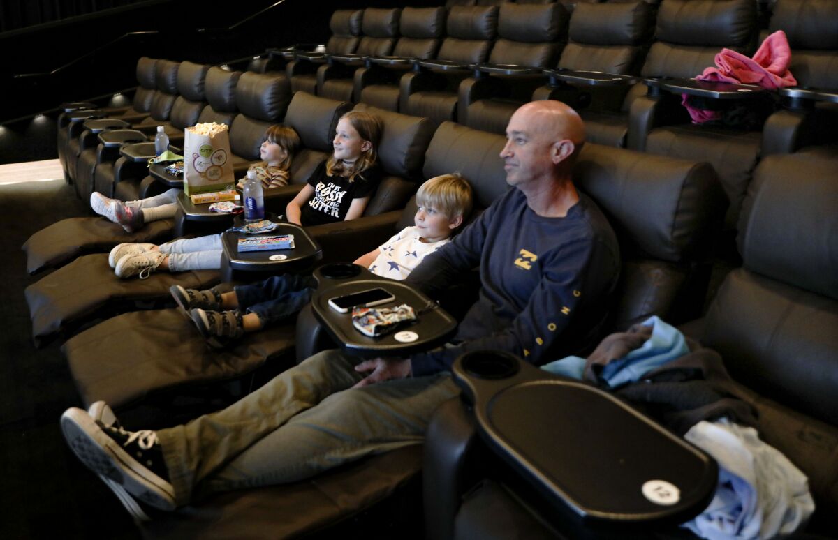 Jason Mahrdt watches a movie with his kids at the Angelika Film Center.
