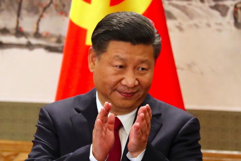 FILE - In this Oct 25, 2017, file photo, Chinese President Xi Jinping claps while addressing the media as he introduces new members of the Politburo Standing Committee at Beijing's Great Hall of the People. On a proposal made public Sunday, Feb. 25, 2018, China's ruling Communist Party proposes removing a limit of two consecutive terms for the president and vice president. (AP Photo/Ng Han Guan, File)