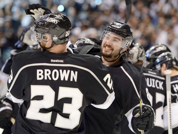 Kings defenseman Drew Doughty and winger Dustin Brown celebrate after sweeping the St. Louis Blues in their conference semifinal playoff series with a 3-1 victory in Game 4 of the Western Conference semifinals at Staples Center.