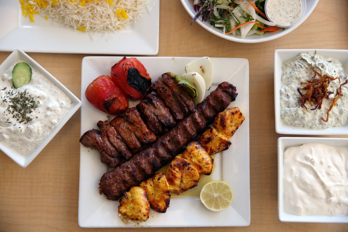 Taste of Tehran kebab plate with rice, house salad and yogurt