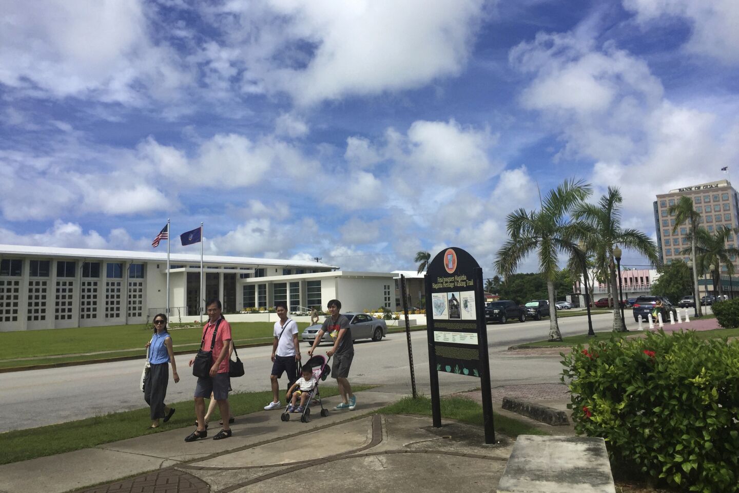 People walk around Hagatna, the capital of Guam, on Wednesday, Aug. 9, 2017. Despite government assurances, residents of the U.S. territory say they're afraid after being caught in the middle of rising tensions between President Trump and North Korea.