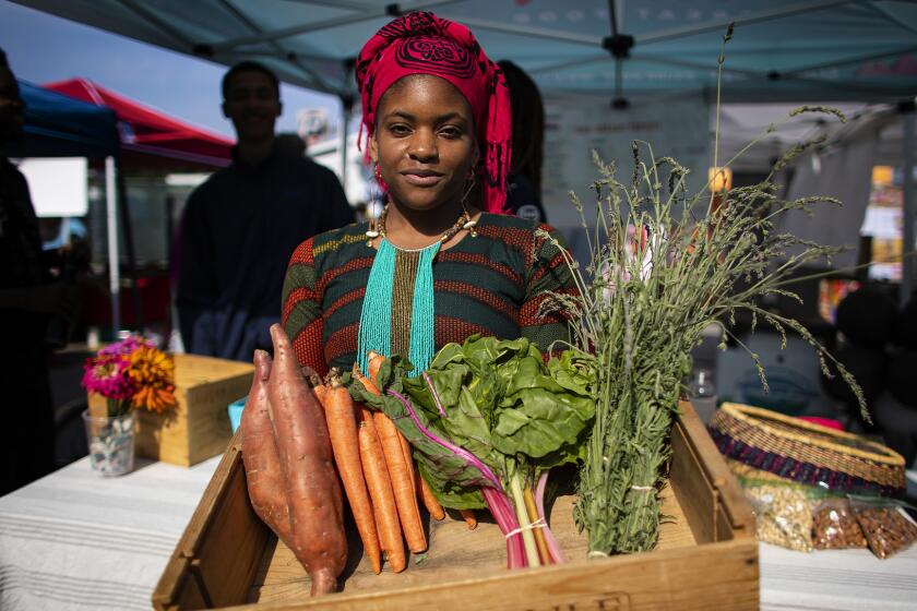 LOS ANGELES, CA - JUNE 15, 2019: Olympia Auset is the owner and founder of S?prmarkt, allow cost organic grocery servicing low income communities in L.A. on June 15, 2019 in Los Angeles, California. On a recent Saturday, she was selling her organic produce at Leimert Park Village.(Gina Ferazzi/Los AngelesTimes)